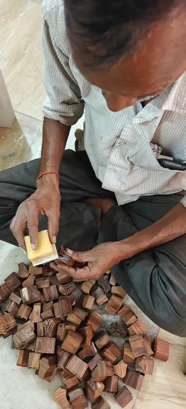 An artisan holding a wooden printing block